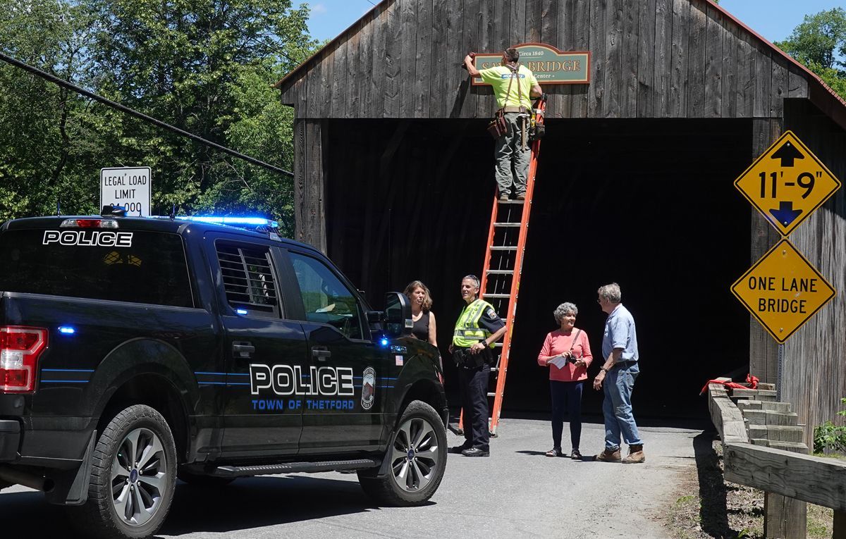 Festive installation of Sayre Bridge signs